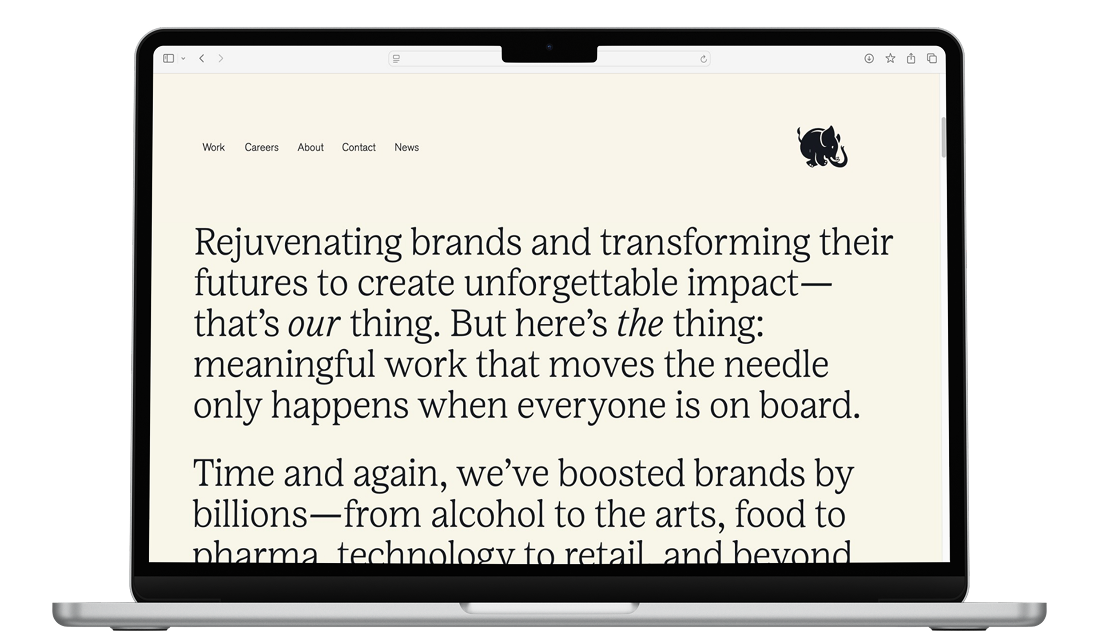 Laptop displaying a modern brand website with editorial typography